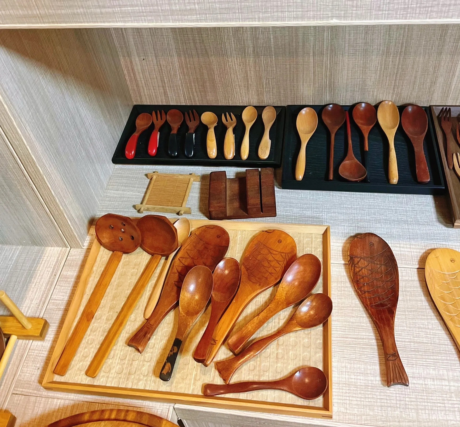 Wooden kitchen utensil samples displayed for review