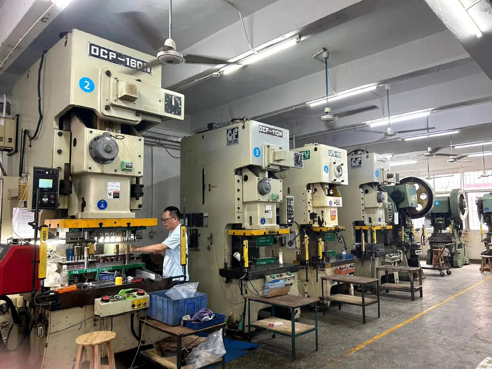 Workers operating metal presses