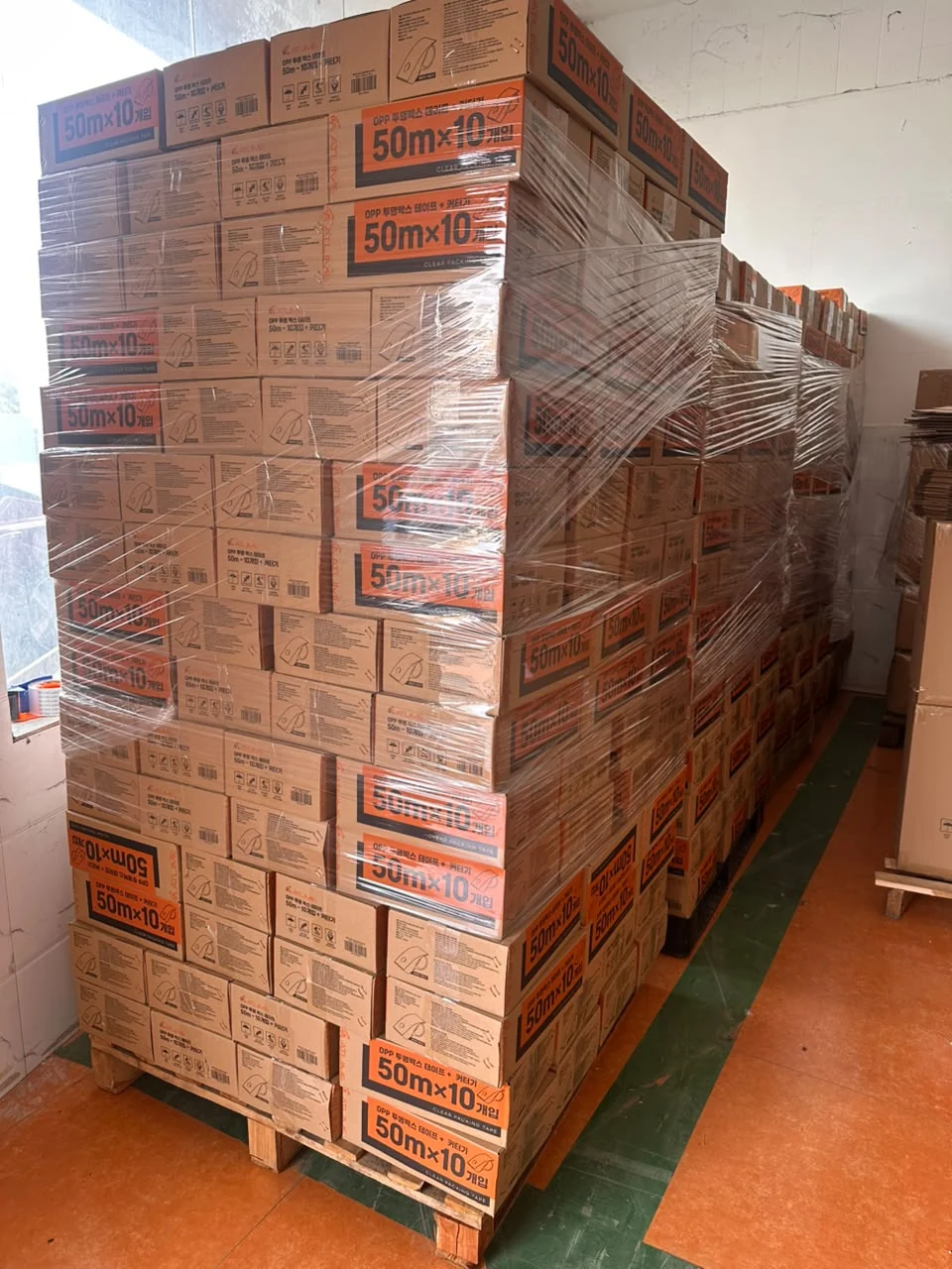 Real NitaSource packing tape project showing carton-packed goods on wrapped pallets