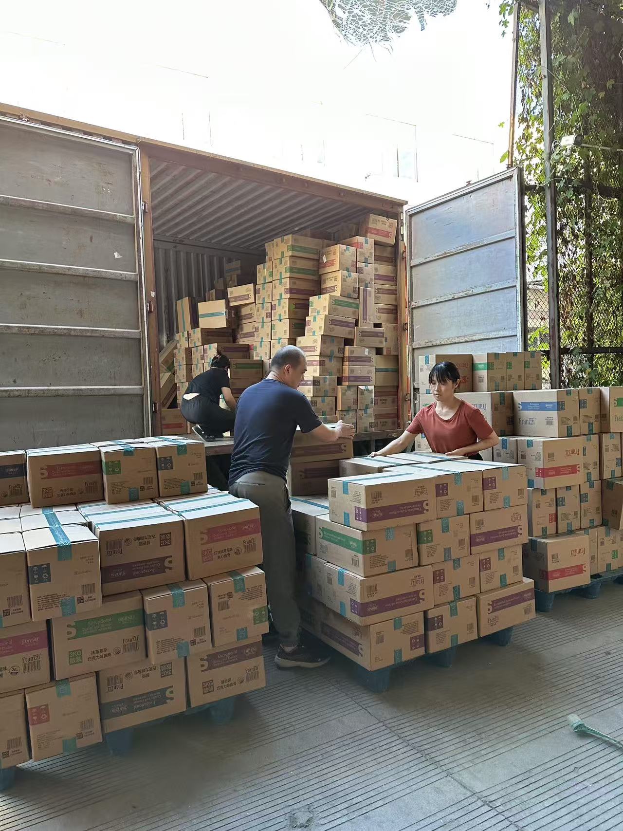 Cartons being handled beside a truck at a cooperating supplier