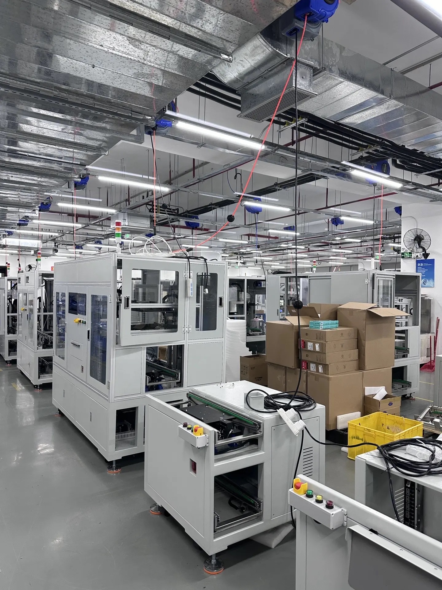 Industrial production equipment and packaging cartons in a factory workshop